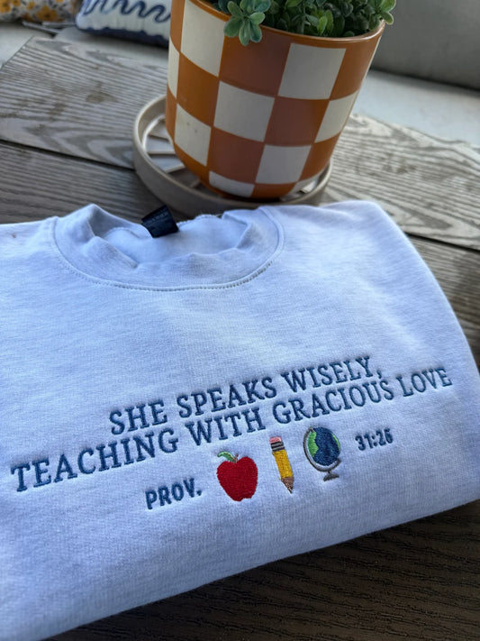 She Speaks Wisely Embroidered Teacher Crewneck Sweatshirt | Gildan Heavy Blend Ash Grey