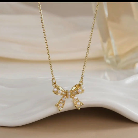 Gold Bow Necklace with Pearl Accents