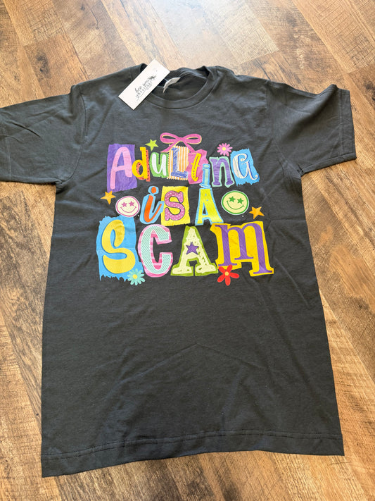 “Adulting Is a Scam” Fun Letter Graphic T-Shirt – Funny Retro Style Tee